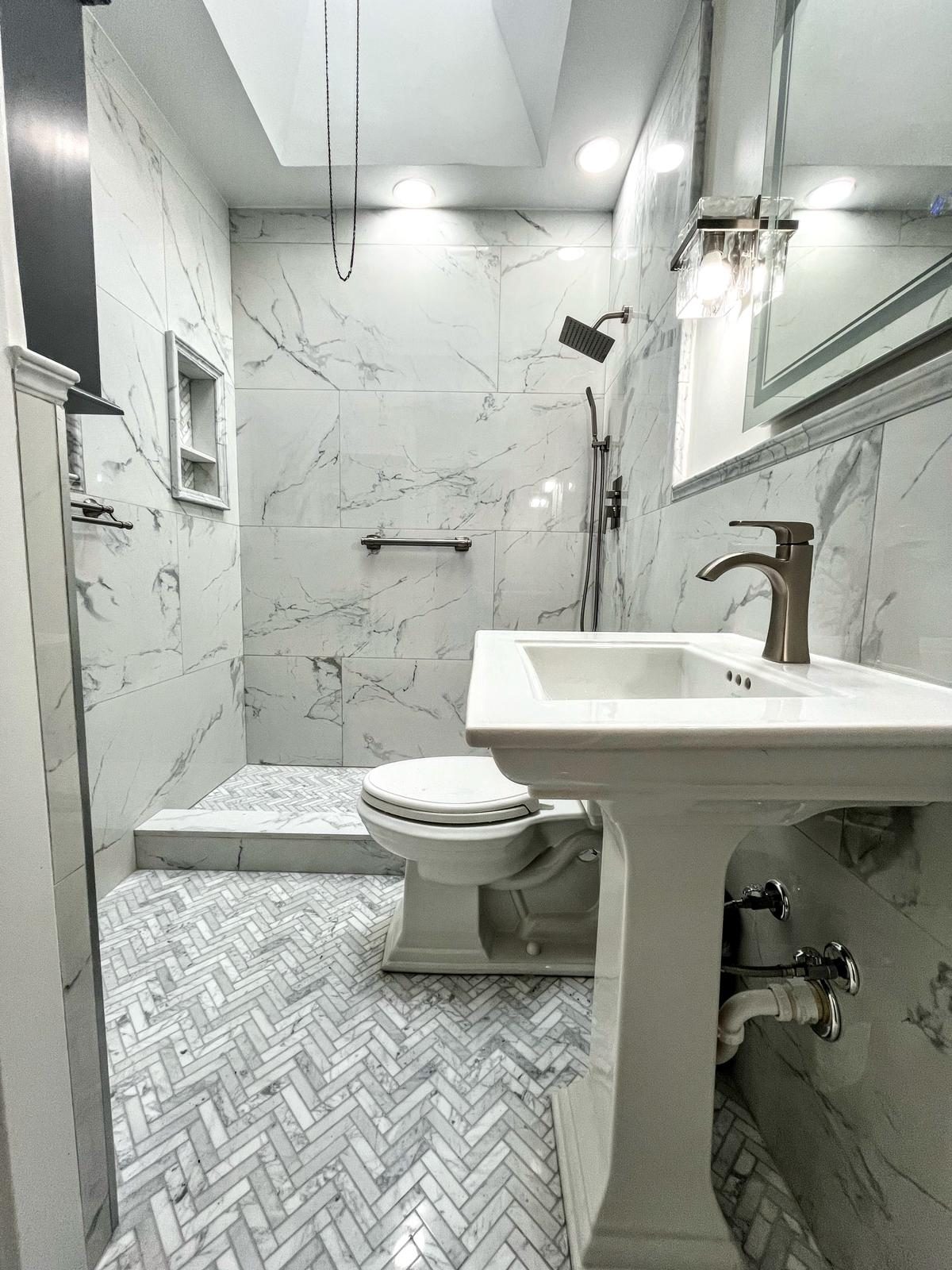 licensed contractor reviewing bathroom renovation blueprints