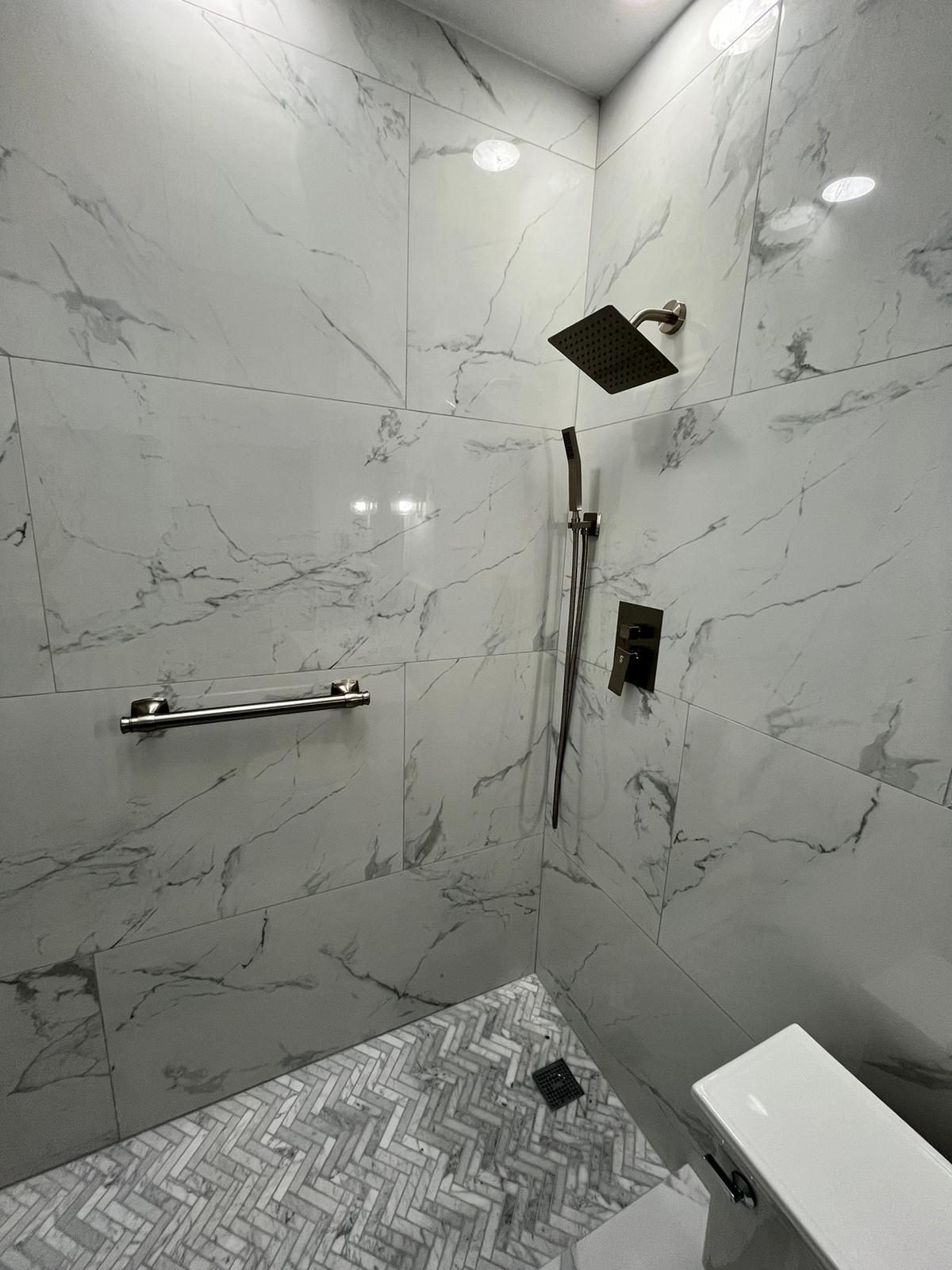 inspector checking plumbing rough-in during bathroom remodel