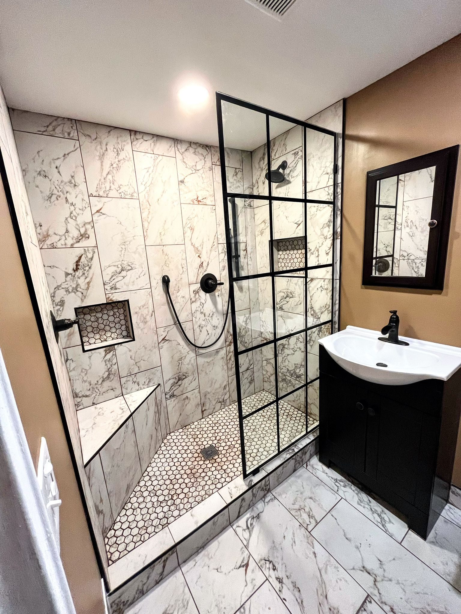 tile installation progress in bathroom shower and floor during renovation project