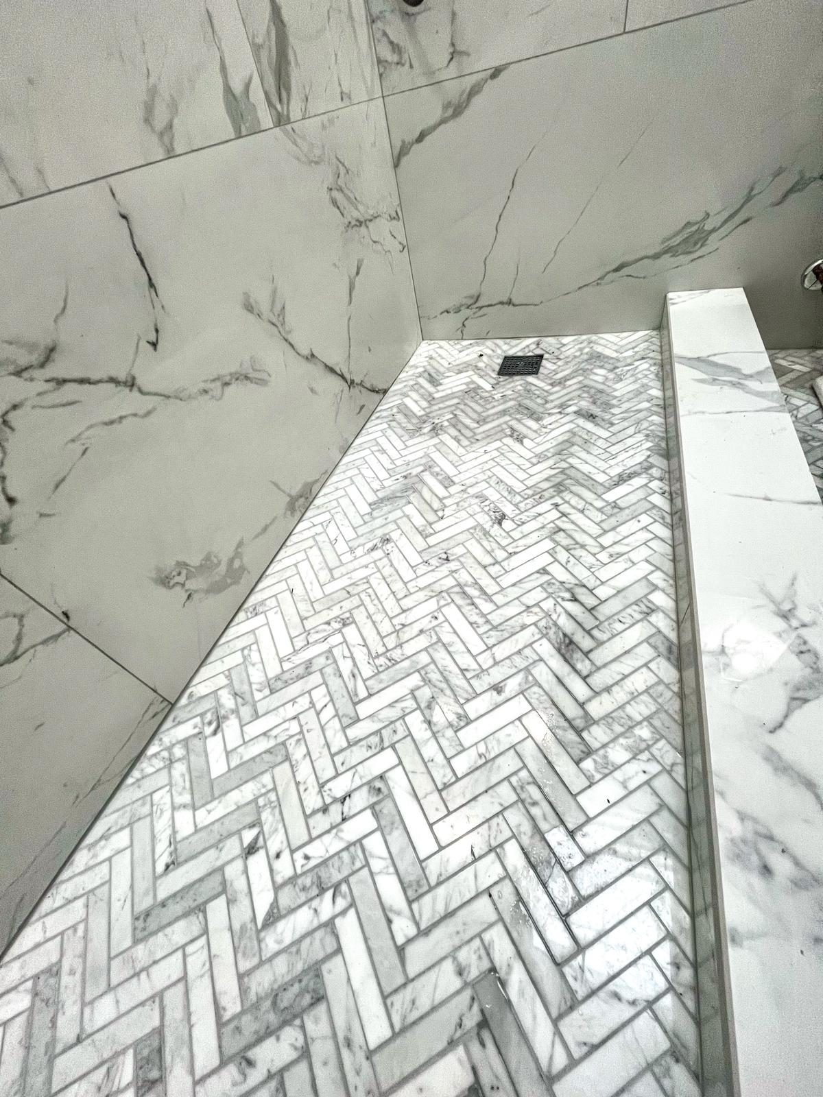 ceramic tile shower wall with mosaic accent