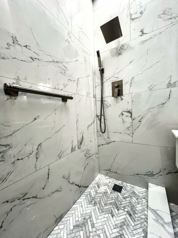 professional bathroom waterproofing membrane installation over cement backer board in shower enclosure