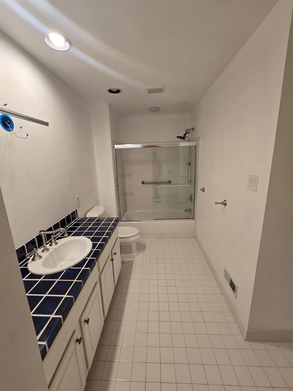 Bathroom before renovation in Ambler, PA, showing the original vanity and shower