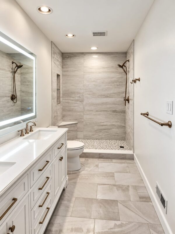Renovated bathroom in Ambler, PA, with white vanity and tiled shower